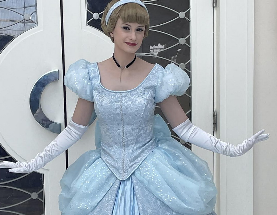 A cosplayer dressed as Cinderella in a shimmering blue ballgown
